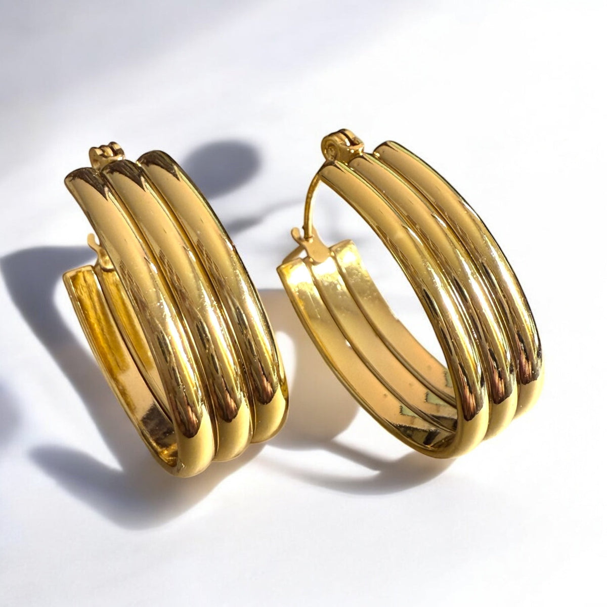 Gold hoop earrings on a white background